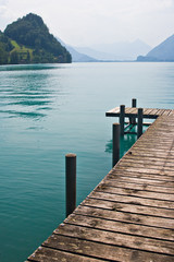 Pier by a turquoise lake in Switzerland.