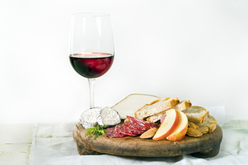 wine cheese bread and fruits on white