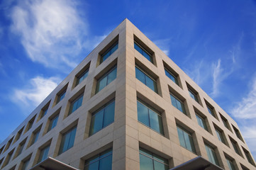 Fototapeta na wymiar High modern building on a background of the blue sky