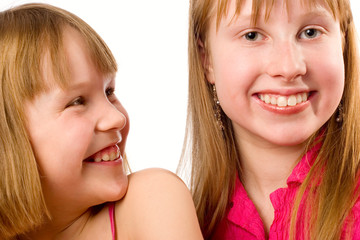 Two girls joyful smiling isolated over white