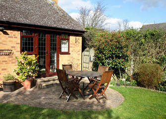 Springtime  in an English Garden with patio table and chairs
