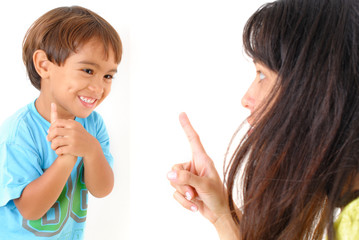 Woman complaining with child that laughs .