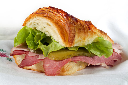 croissant sandwich with Corned Beef and ham