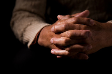 A shot of hands of an old man praying
