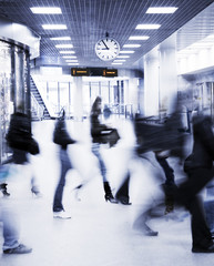 motion blurred crowd under clock