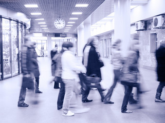 motion blurred crowd under clock