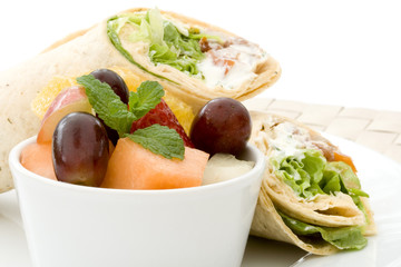 Small bowl of fruit salad with tortilla wraps