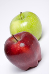 Red and green apples on a light background