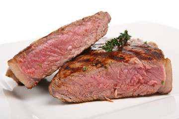 Rare sirloin steak garnished with thyme