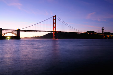 South tower of Golden Gate Bridge glows and beautiful sunset sky