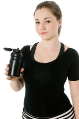 Young caucasian girl drinking from an exercise bottle