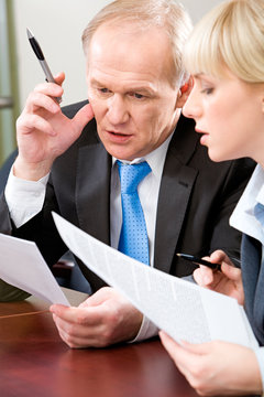 Portrait of confident boss and woman planning their work