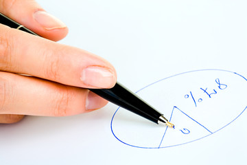 Closeup of human hand holding a pen and drawing diagram 