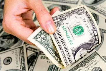 Close up of woman&rsquo;s hand with one-dollar banknote 
