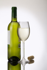 A glass and bottle of white wine