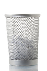 Mesh trash bin with some paper inside