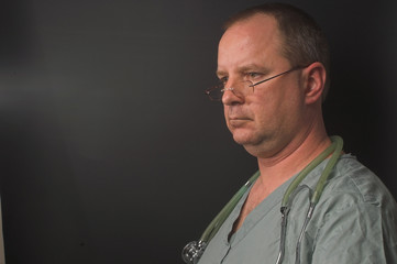 A medical doctor waiting on his next patient.