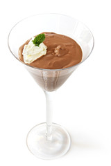 Chocolate mousse in a martini glass, with cream and mint.