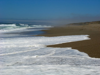 Blue sky seascape coastline with few clouds on it.