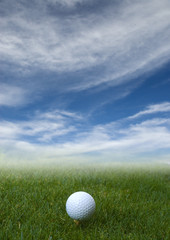 golf ball on the grass with blue sky