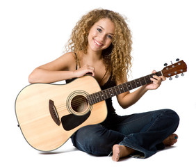 An attractive young teenage woman with an acoustic guitar 