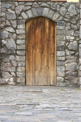 Fototapeta na wymiar Wooden door in an old wall