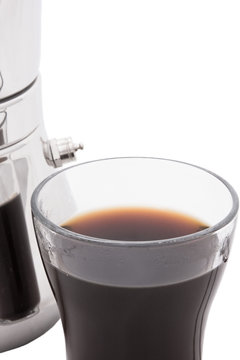 A coffee percolator and coffee in a cup
