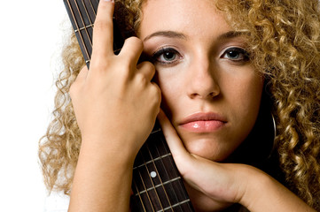 An attractive young teenage woman with an acoustic guitar 