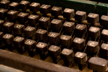 Isolated old dusty typewriter keyboard. author copyright concept
