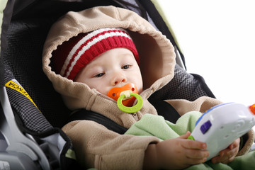 Baby with toy in car seat