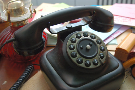Black vintage telephone on a working desk