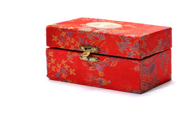 A small patterned box, with a metal clasp, over white.