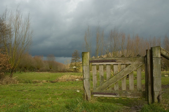 Storm over a field with fence. Autumn 2007.