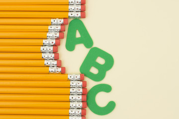 Row of pencils and letters with copy space