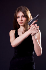 lady in black handing pistol.
