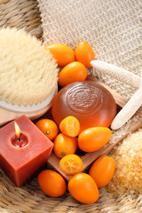 Fototapeta na wymiar bar of gliceryne soap and bath salt - natural kumquat bath