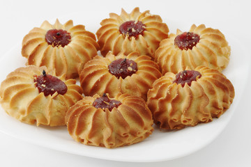 Sweet cookies with jam on the plate