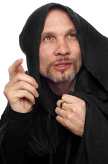 monk or maybe sorcerer in black clothing with hood