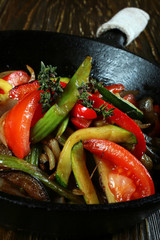 Fried vegetable with spice in black pan