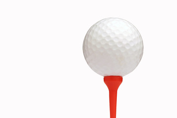 White golf ball on red tee over white