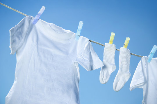 Eco friendly  laundry drying on clothes line against a blue sky 