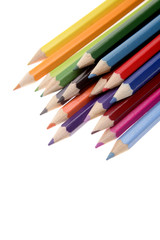 Colored pencils over white background