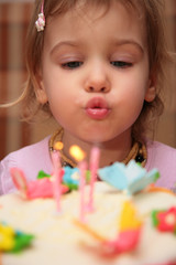 little girl blowing birthday candles, blur