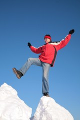man steps from one snowy chunk to another