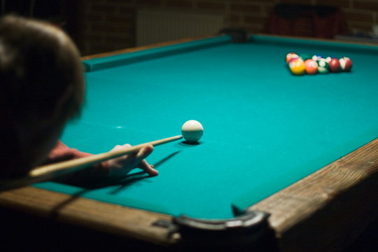 Man playing billiards on the Green table
