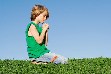 christian child kneeling praying