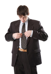 Man in suit corrects tie