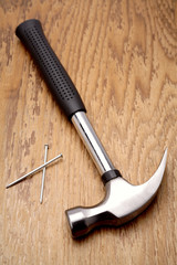 Hammer and nails on wooden panel