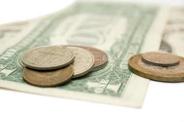dollars and russian metallic coins on the white isolated backgro