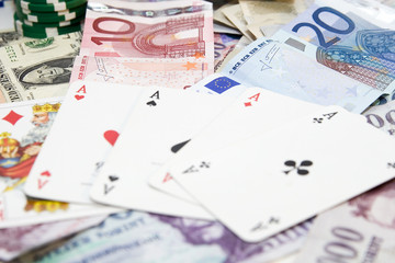 Fototapeta na wymiar Poker hands - cards have focus with poker chips and money
